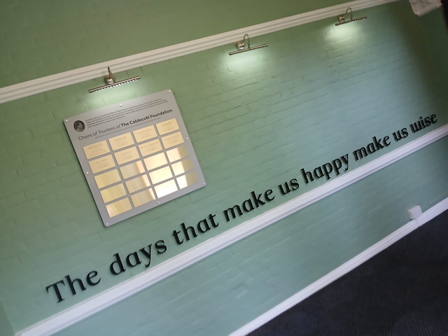 "The days that make you happy make you wise" on the wall of the lobby at the Caldecott Foundation School