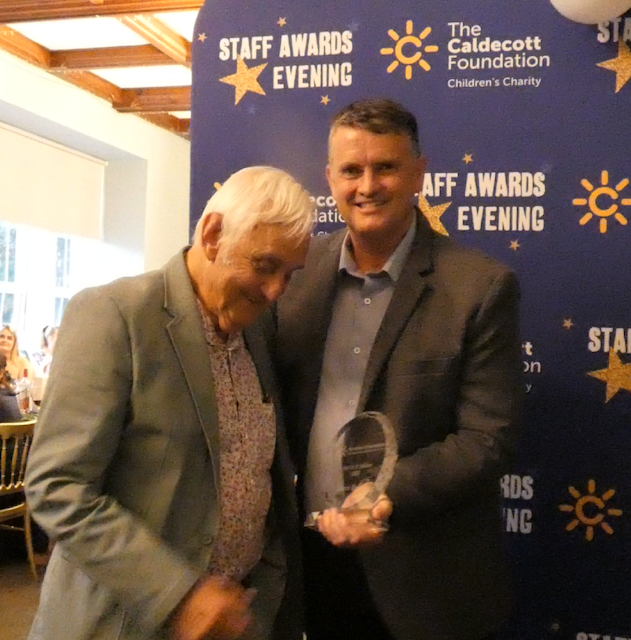 Simon Rodway receiving award from Nick Barnett on his 93rd birthday, 2025